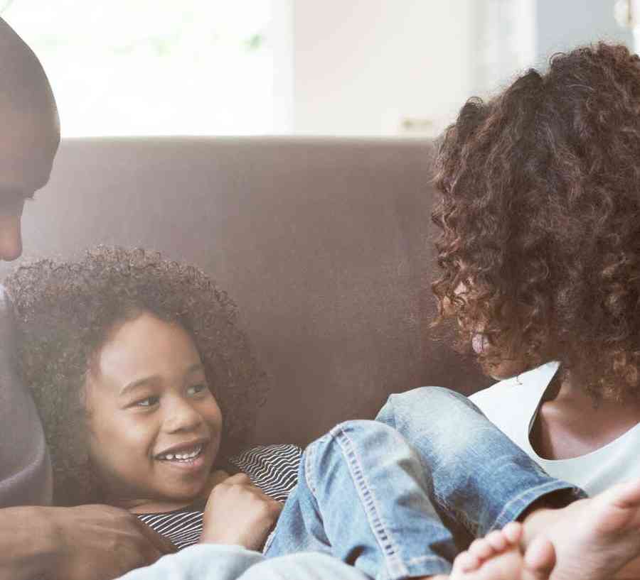 Family relaxing on a couch.