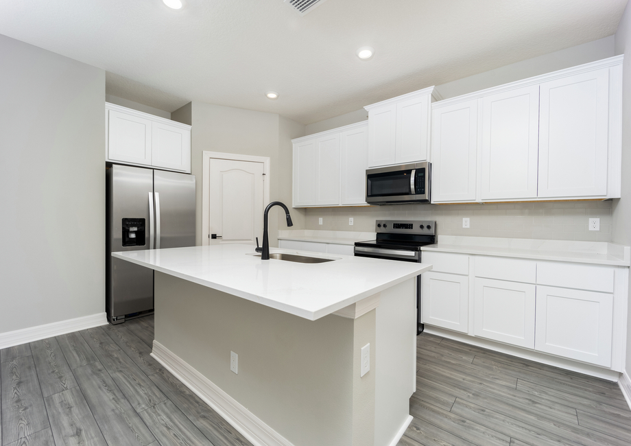 The kitchen has a large island ready to be the heart of your home