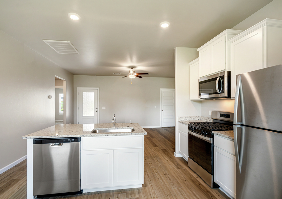 The kitchen island overlooks the spacious living area.