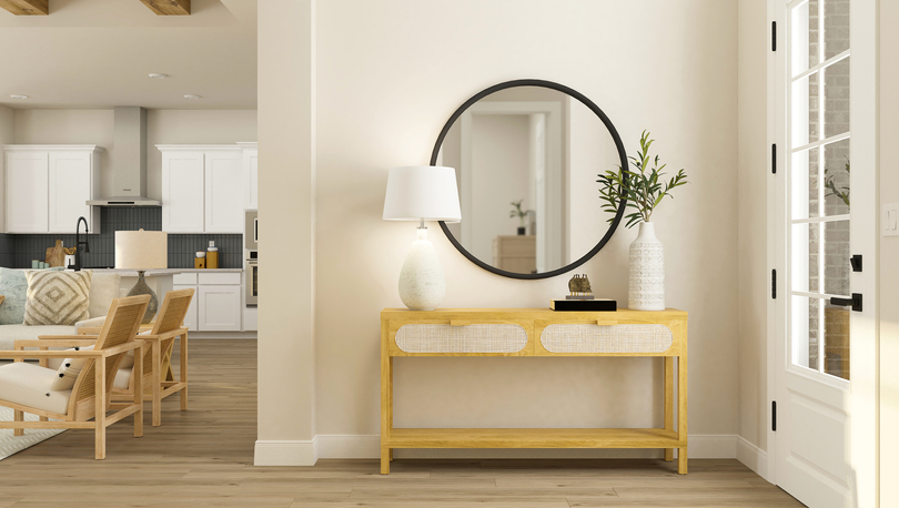 Rendering of the foyer decorated with a
  console table and large, round mirror.Â 