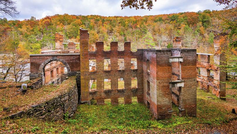 Atlanta, Georgia Sweetwater Creek State Park Old Mill ruins with remnants of a brick factory and hills filled with Autumn trees in the background