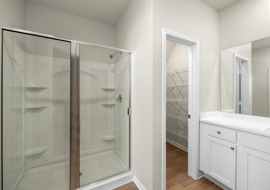 Master bathroom with a step in shower and a walk-in closet