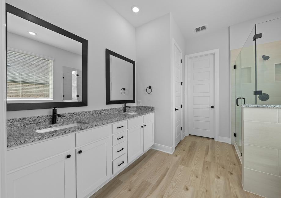 The master bath showcases a large vanity and a walk-in shower.