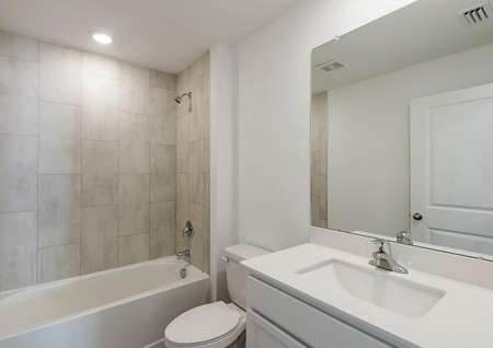 Spare bathroom with large countertop space and a soaker tub.