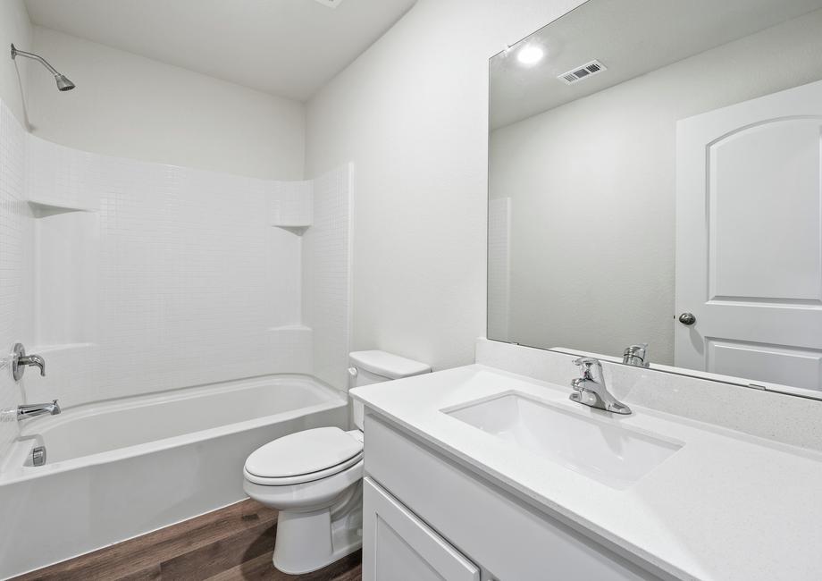 The secondary bathroom has plenty of counterspace and a large shower-tub combo.