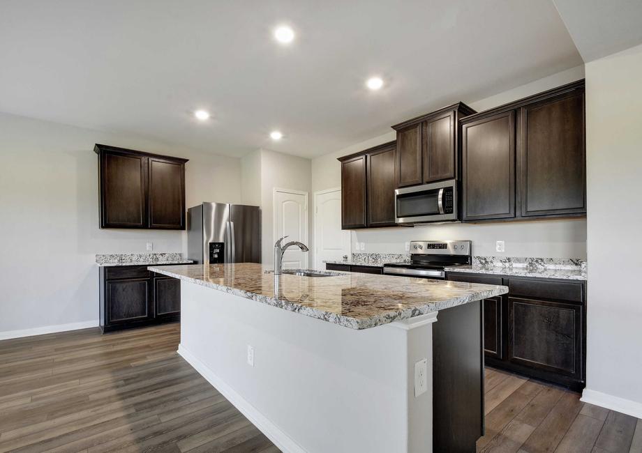 Upgraded kitchen with an oversized island and stainless steel appliances.