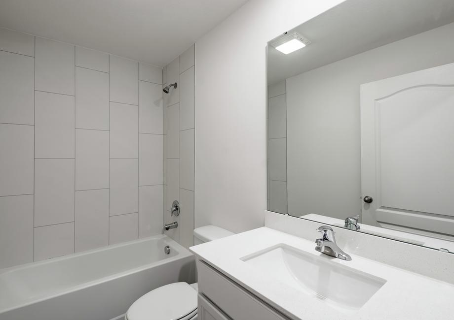 The guest bathroom has a spacious vanity ready for your guests to use