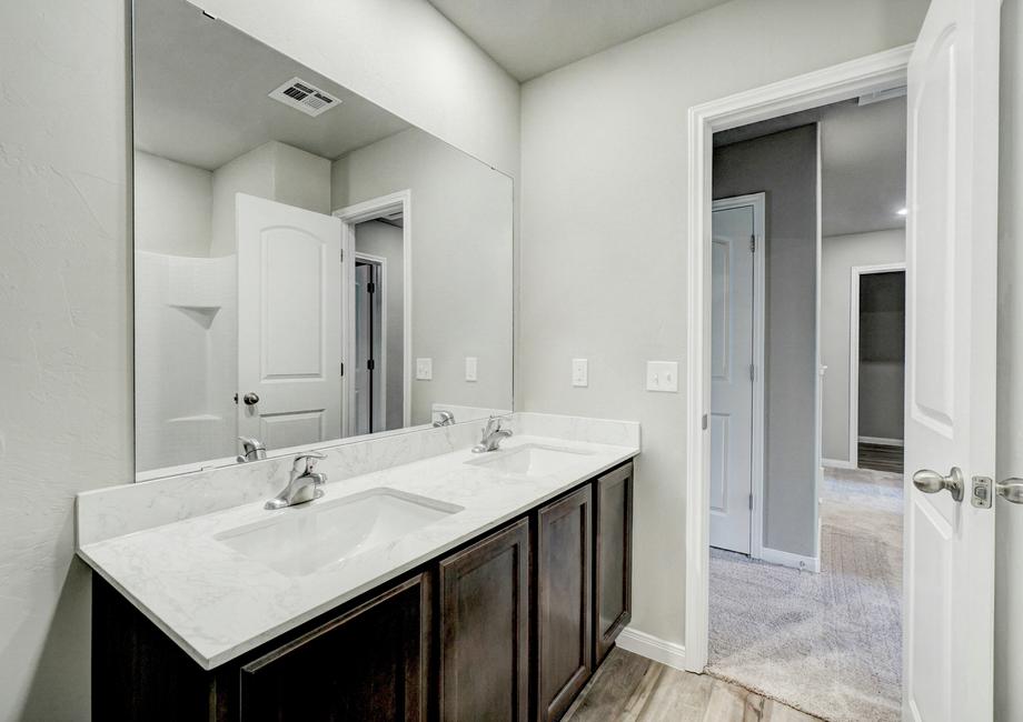 A full bathroom with double sinks.