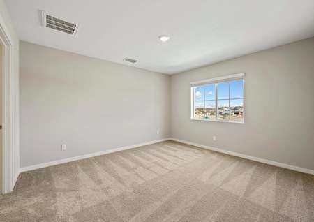 The master bedroom has carpet and a large window.