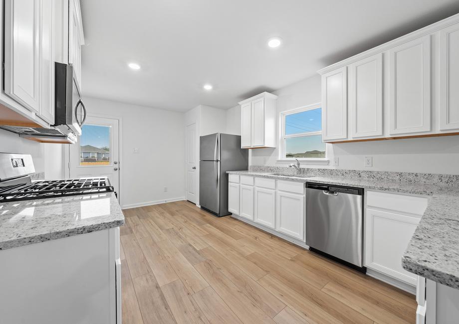 The kitchen is filled with stainless steel appliances