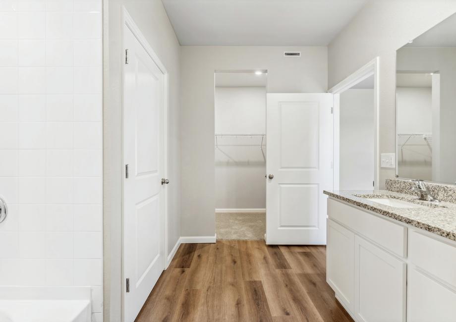 The master bathroom is spacious with a large vanity.