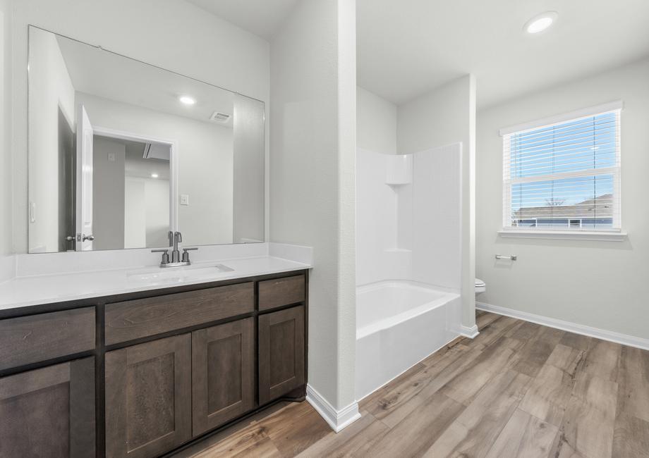 The secondary bathroom of the Cypress has a large vanity and shower-tub combo.
