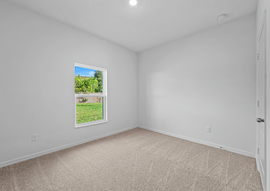 Third bedroom with a window that overlooks the backyard