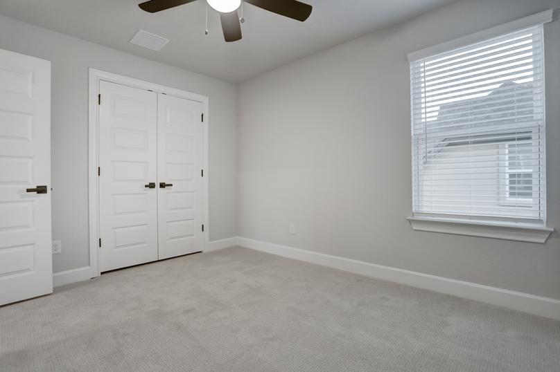 Secondary bedroom with a large closet and window.