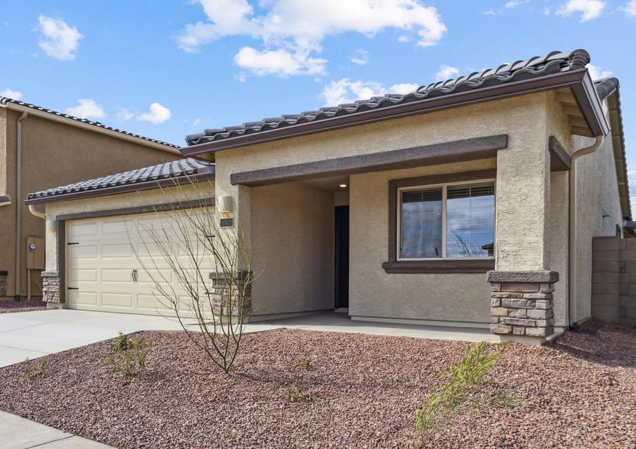 Angled exterior of the Bisbee plan, showcasing the stucco and brick finishes.