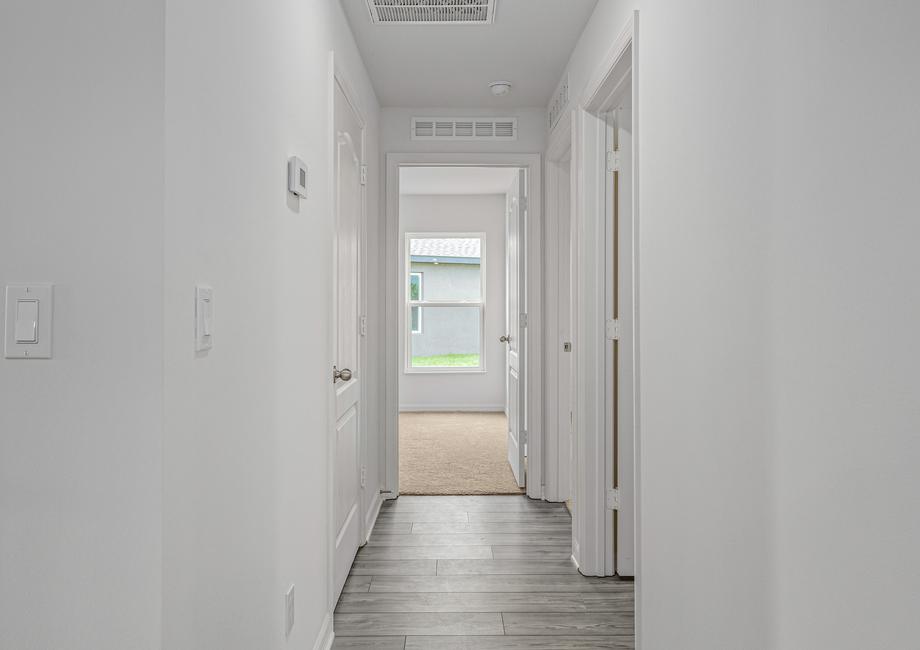 A hallway leads to the two guest bedrooms