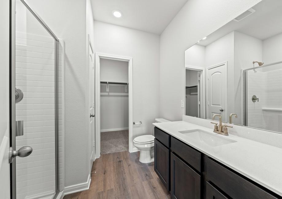 The master bathroom of the Piper has a large vanity space and glass, walk-in shower.