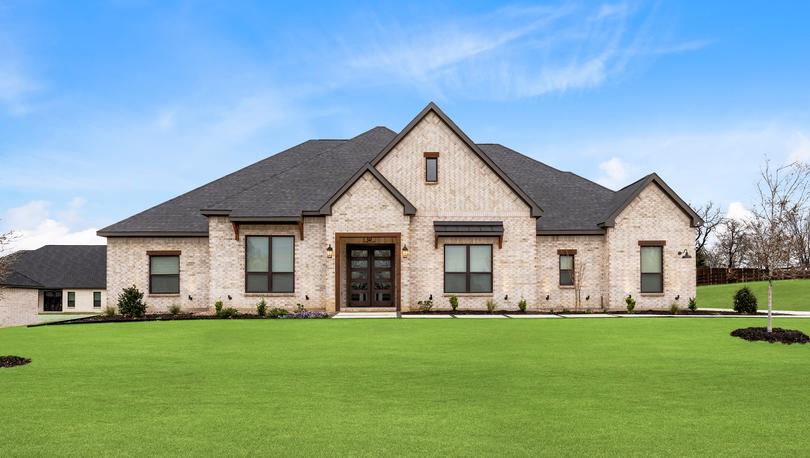 The Stratton II is a beautiful, one-story brick home with wood accents.