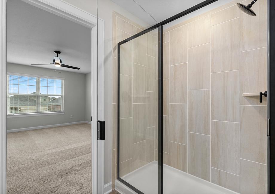 The master bath has a spacious, glass-enclosed shower.