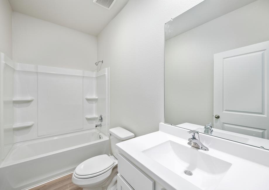 This secondary bathroom has a tub/shower combination.