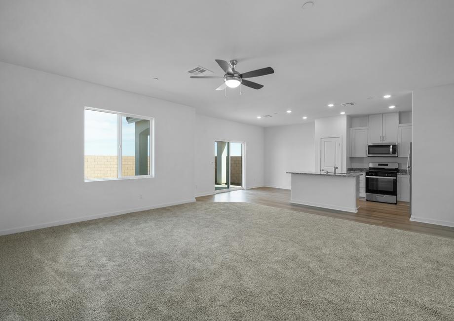 The family room is spacious and has a ceiling fan.