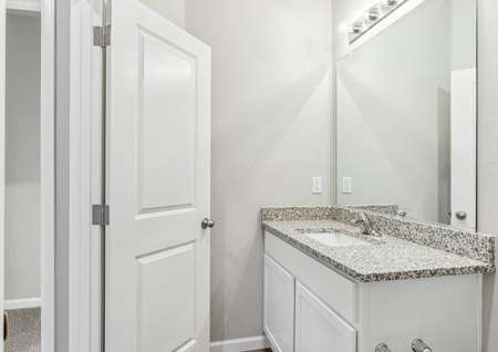 The secondary bathroom has beautiful granite countertops that provide plenty of counterspace.