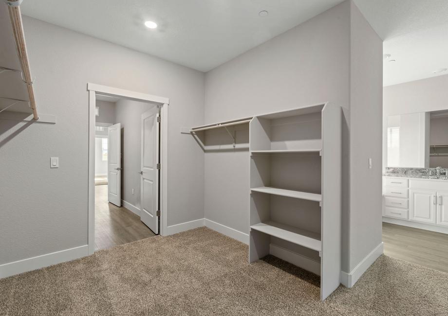 The walk-in closet features plenty of cabinet space.