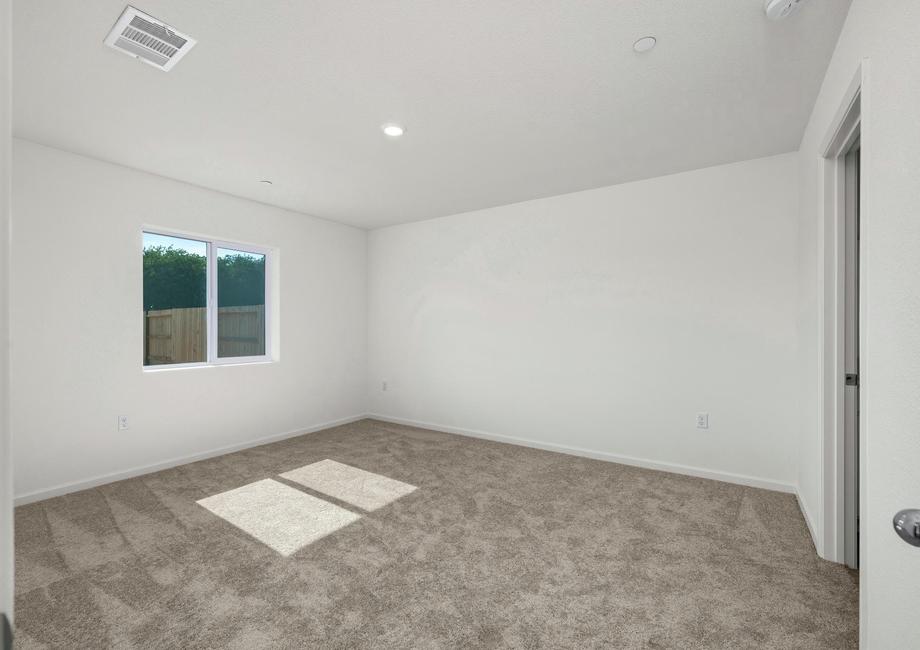 The master bedroom is spacious with a window.