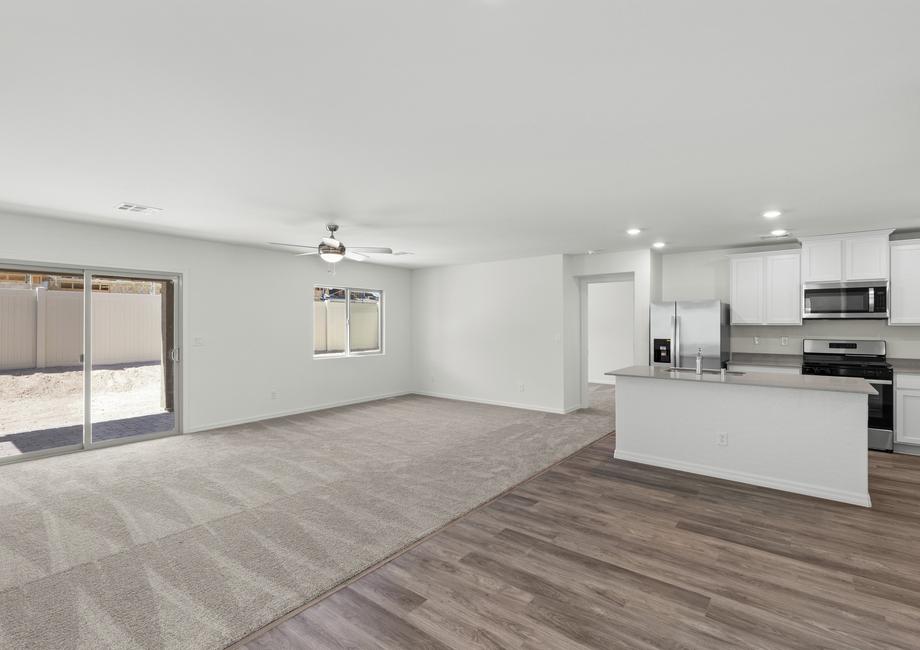 The open layout shows the kitchen open to the dining room and family room.