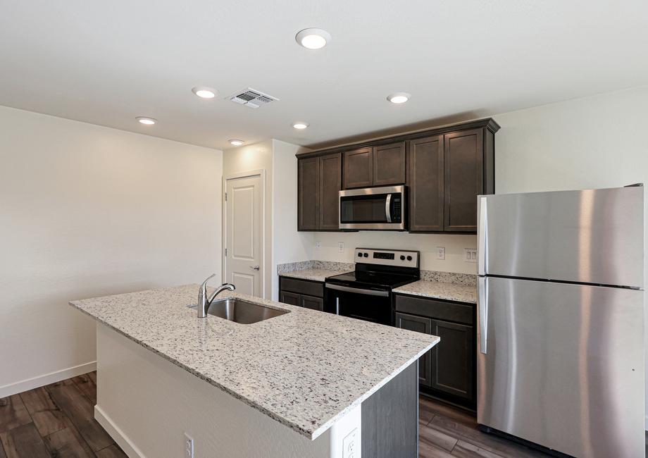 This kitchen has a beautiful granite island.