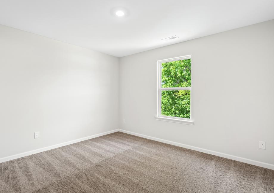 Each of the secondary bedrooms includes tan carpets, closets and bright windows