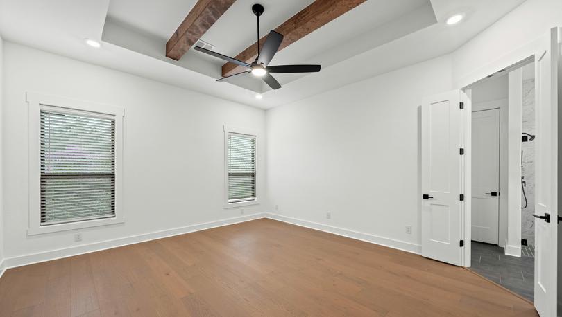 The peaceful master bedroom has two large windows that let in great, natural light.