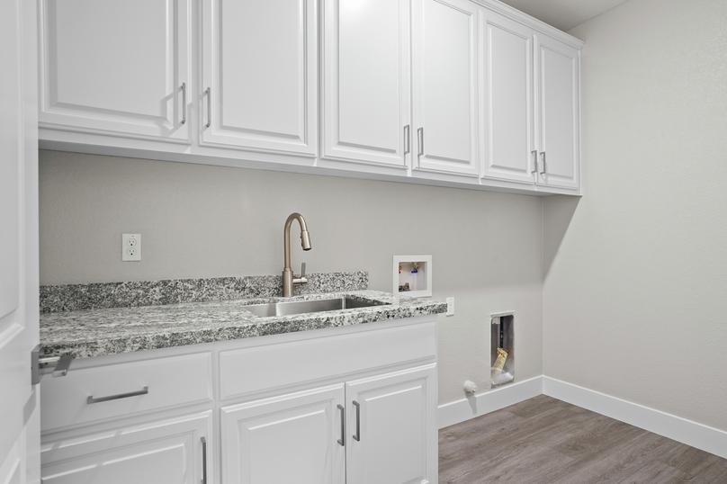 Fully loaded laundry room with a sink