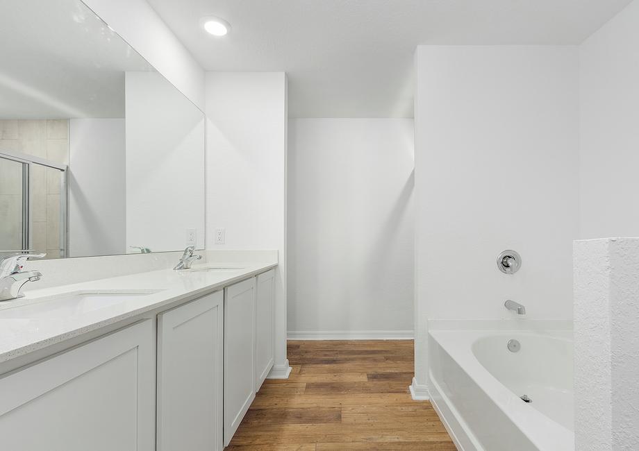 Get ready for your day in the gorgeous master bathroom that includes a double sink vanity, walk-in shower and tub