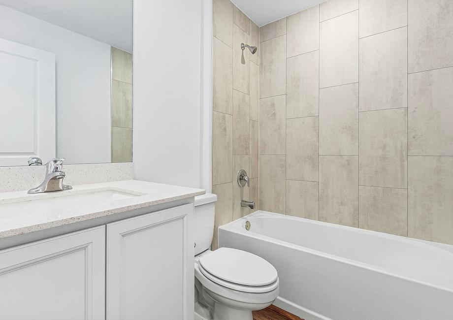 The guest bathroom has a spacious vanity