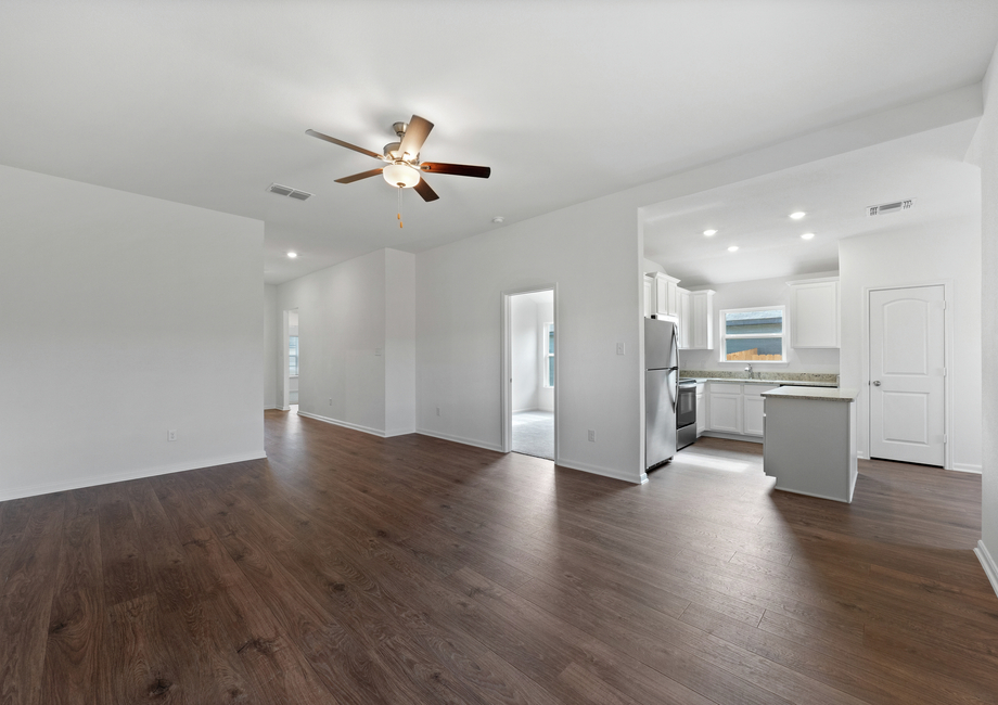 The foyer leads into the family room and adjoining kitchen