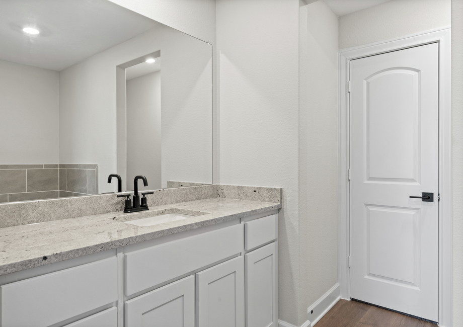 The master bathroom has a large vanity space.