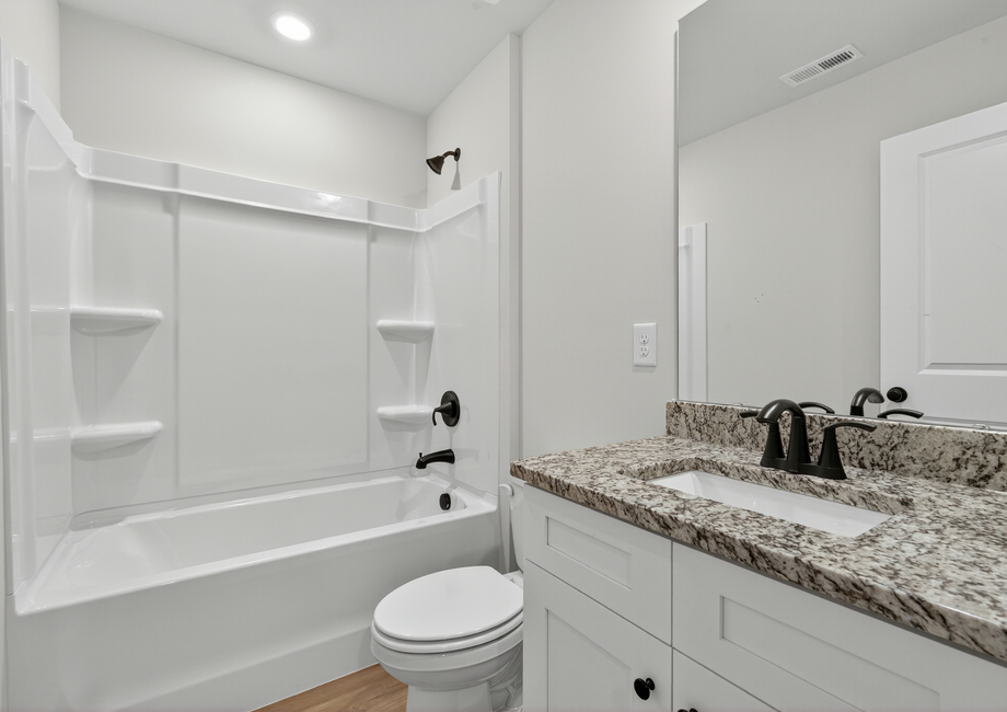The secondary bathroom has a large soaking tub.