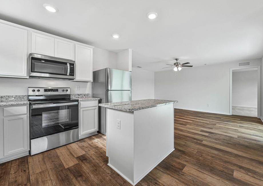 The kitchen also has beautiful white cabinets and granite countertops