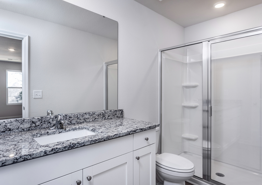 The master bathroom has a glass-enclosed shower