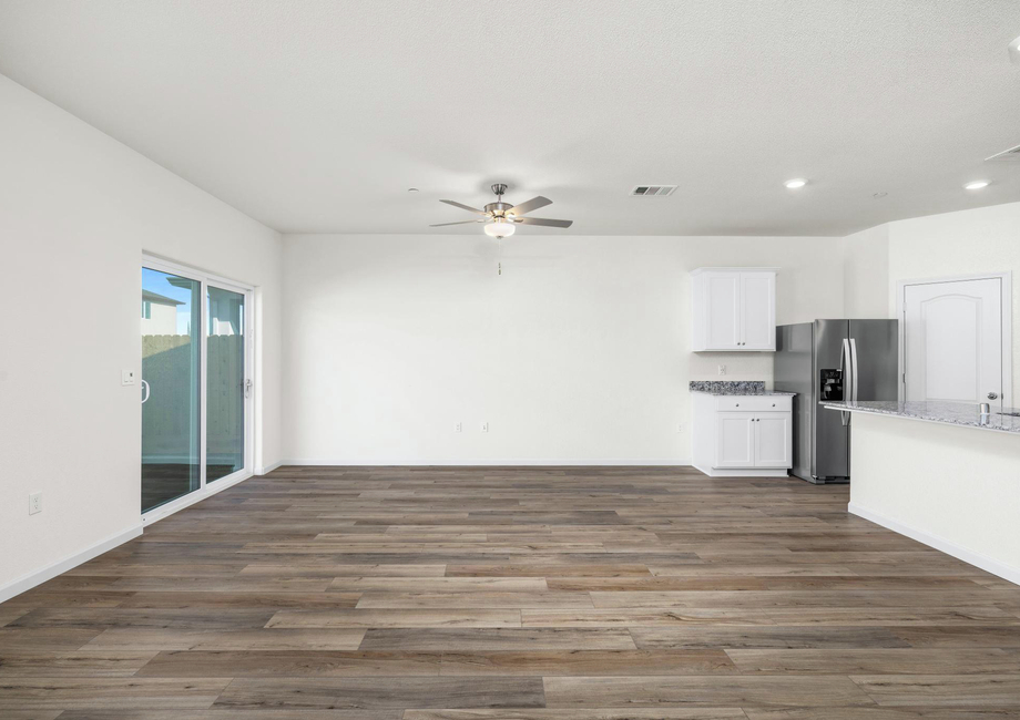 The family room is spacious with a ceiling fan.