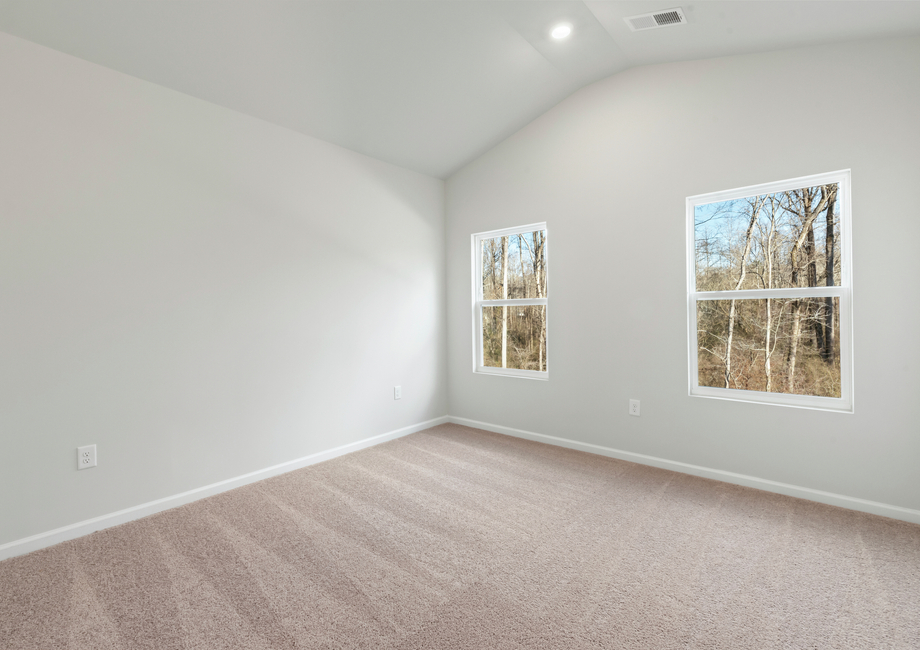 The master bedroom has lots of windows to let in natural light