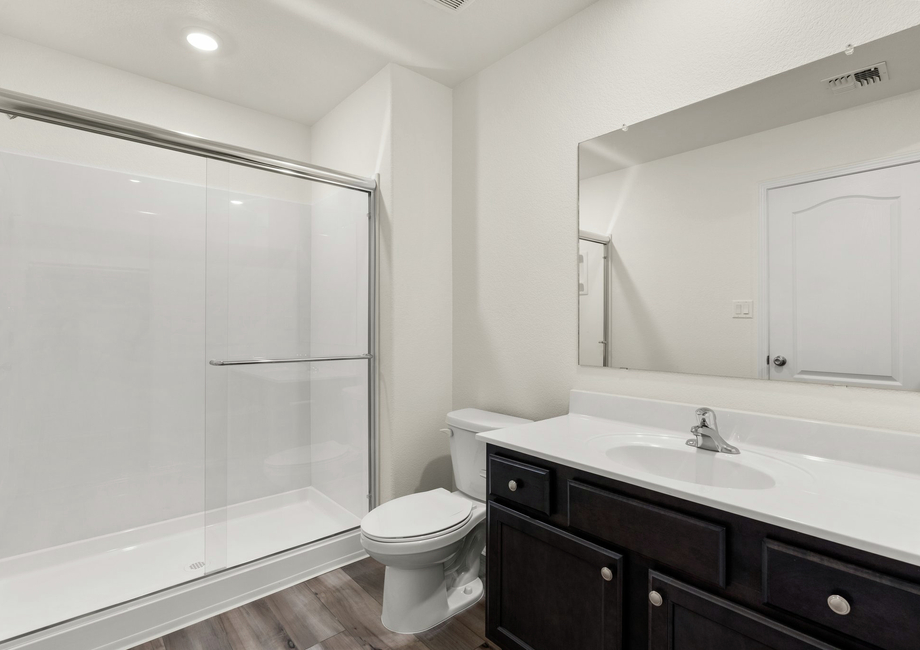 This bathroom has a glass-enclosed shower.