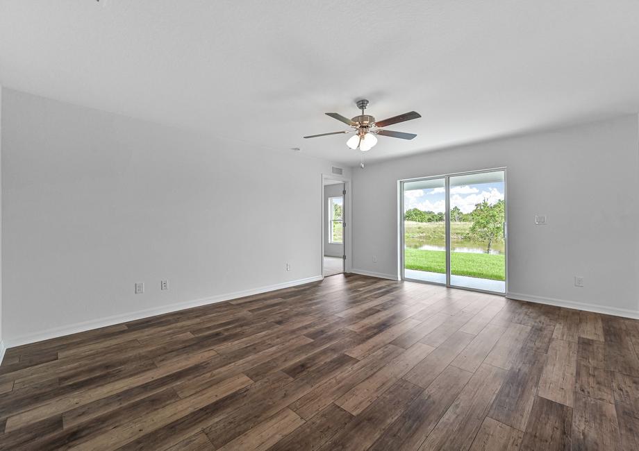 The Amelia's living room with a sliding glass door that leads the the back patio and backyard