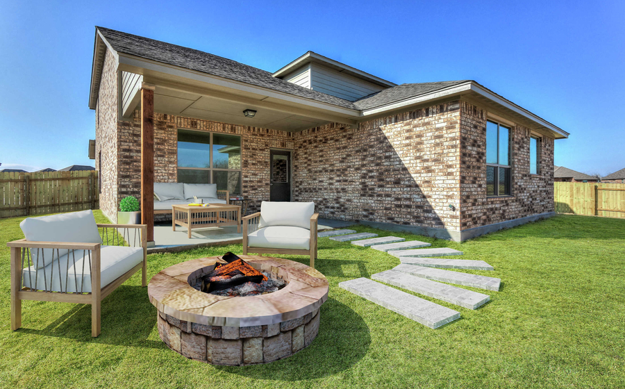 Staged back yard with a fire pit and sitting area.