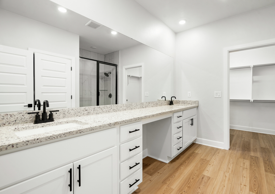 The master bathroom has a spacious vanity with plenty of counterspace and his and hers sinks.