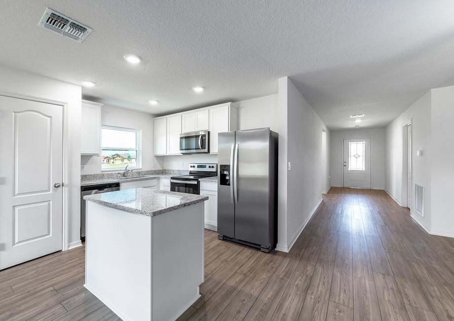 The long foyer enters into the family room and kitchen.