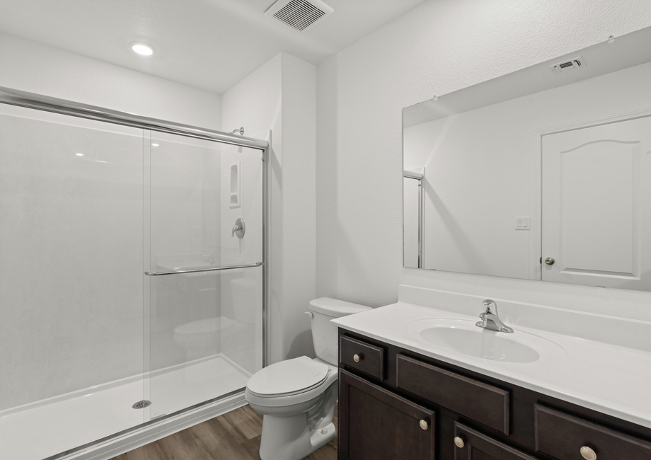 This bathroom has a glass-enclosed shower.