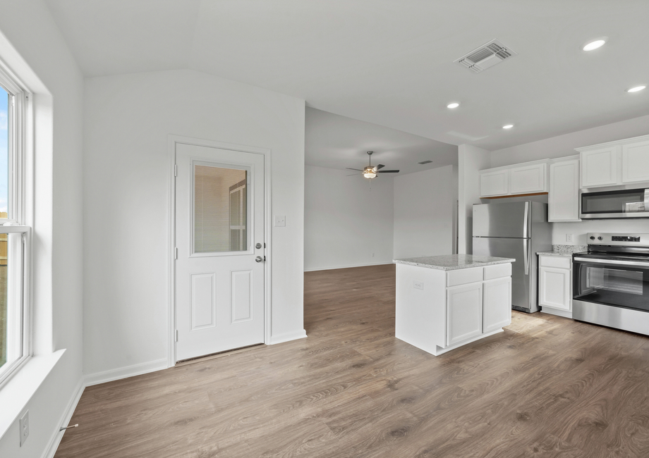 The dining room has a door that leads guest to the back patio