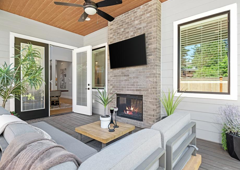 Outside is an incredible covered living area with a fireplace.